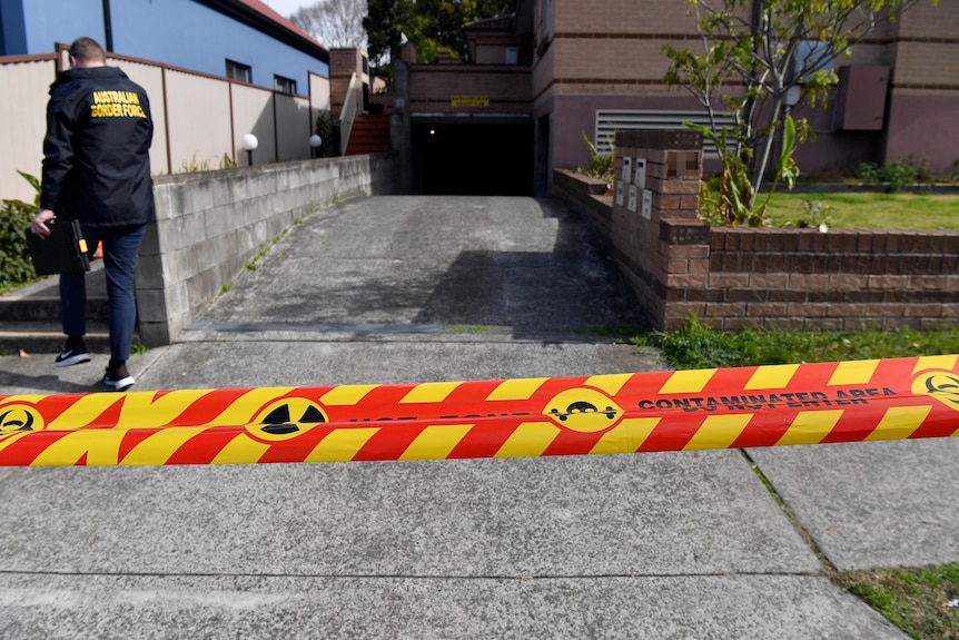 red and yellow hazard tape in front of driveway 