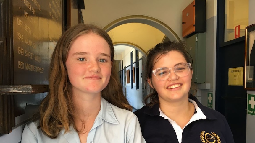 Portrait of two high school girls, Ella Reynolds and Grace Taffa, standing in a hallway of Canterbury Girls High School