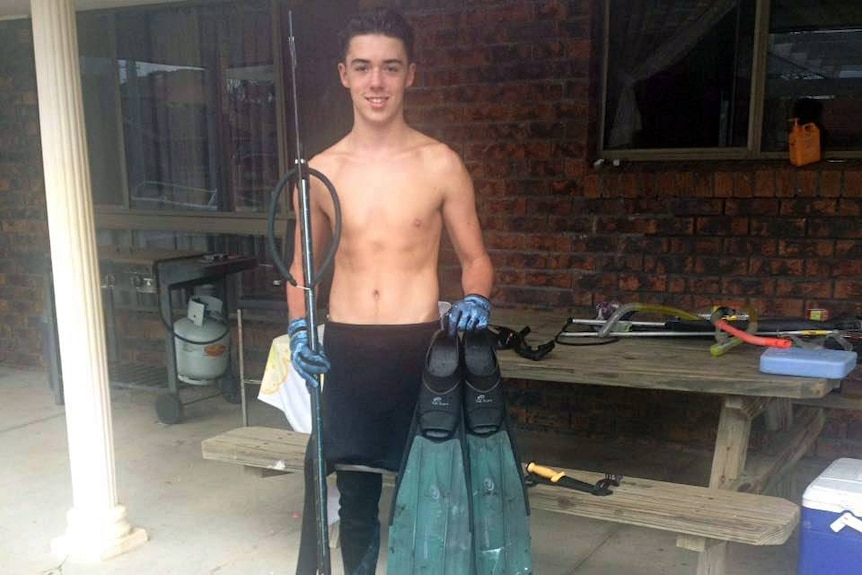 Teenage boy poses in speak fishing gear.