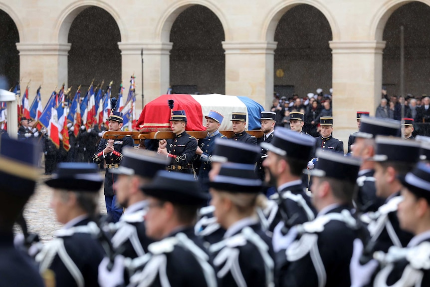 French Republican Guards and cadets from the joint-army military school carry the coffin of policeman Arnaud Beltrame.