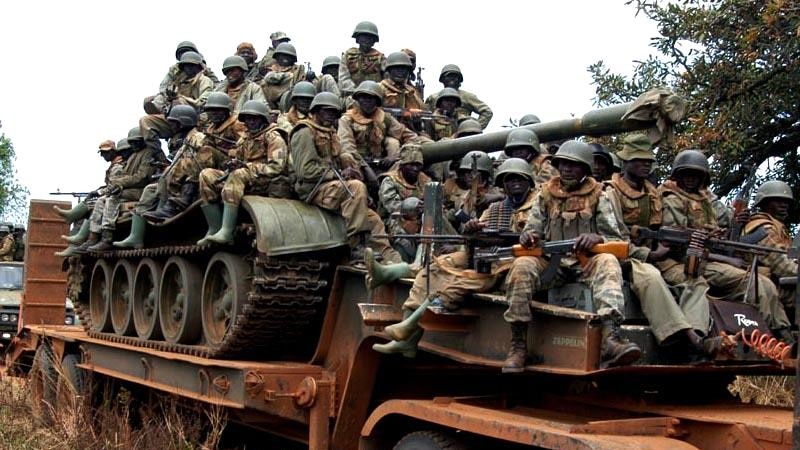 Ugandan soldiers on tank transporter