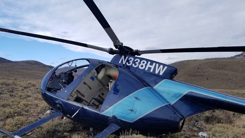 Damaged helicopter lies on a mountainside after the crash.