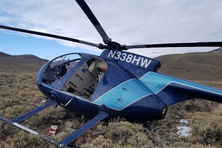 Damaged helicopter lies on a mountainside after the crash.