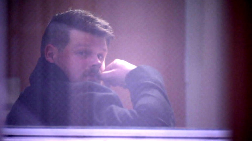Construction site supervisor Luke Daniel Chenoweth looks out a window at the Employment Tribunal.