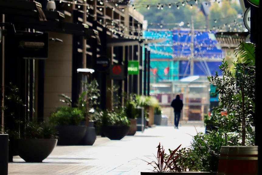 Sydney's usually bustling Barangaroo business district is deserted, with a single man in the distance.