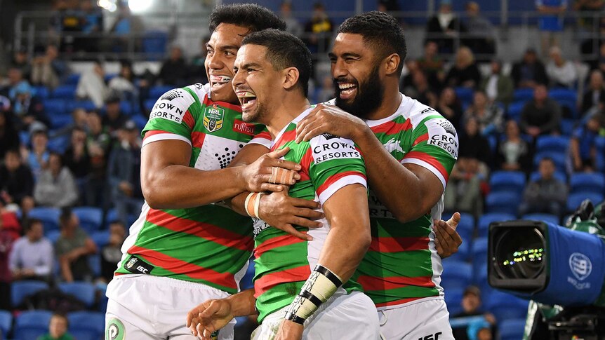 Cody Walker and the Rabbitohs celebrate a try against the Titans.