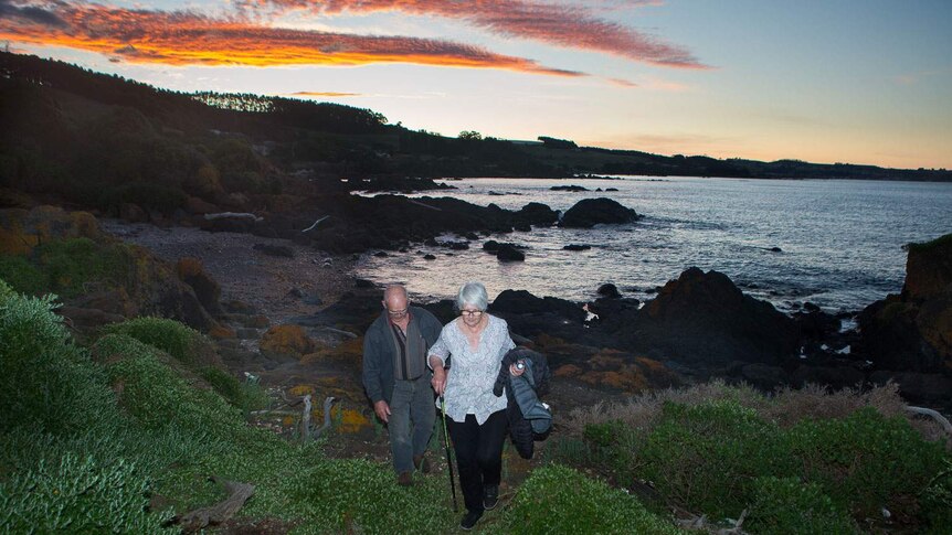Toni and Lance walking the foreshore at sunset
