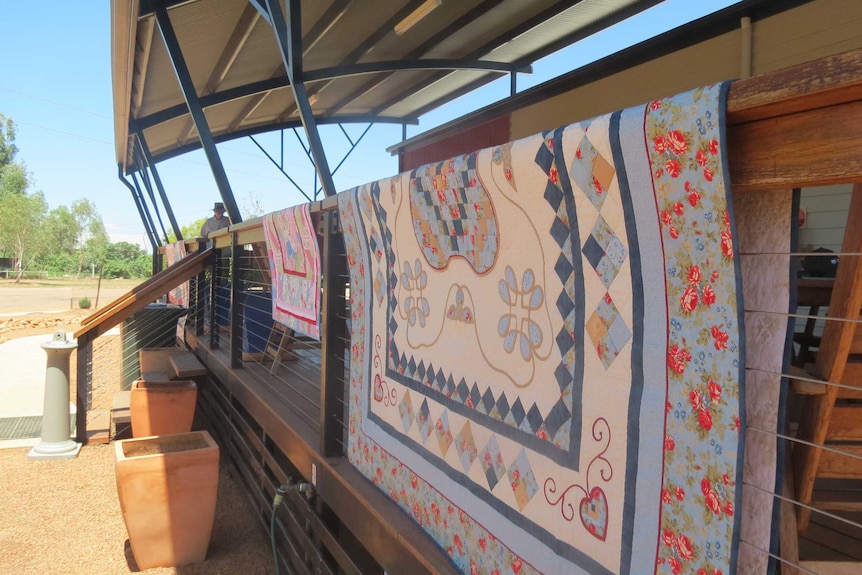 Quilts on verandah railing at an outback hall at Stonehenge, south-west of Longreach,