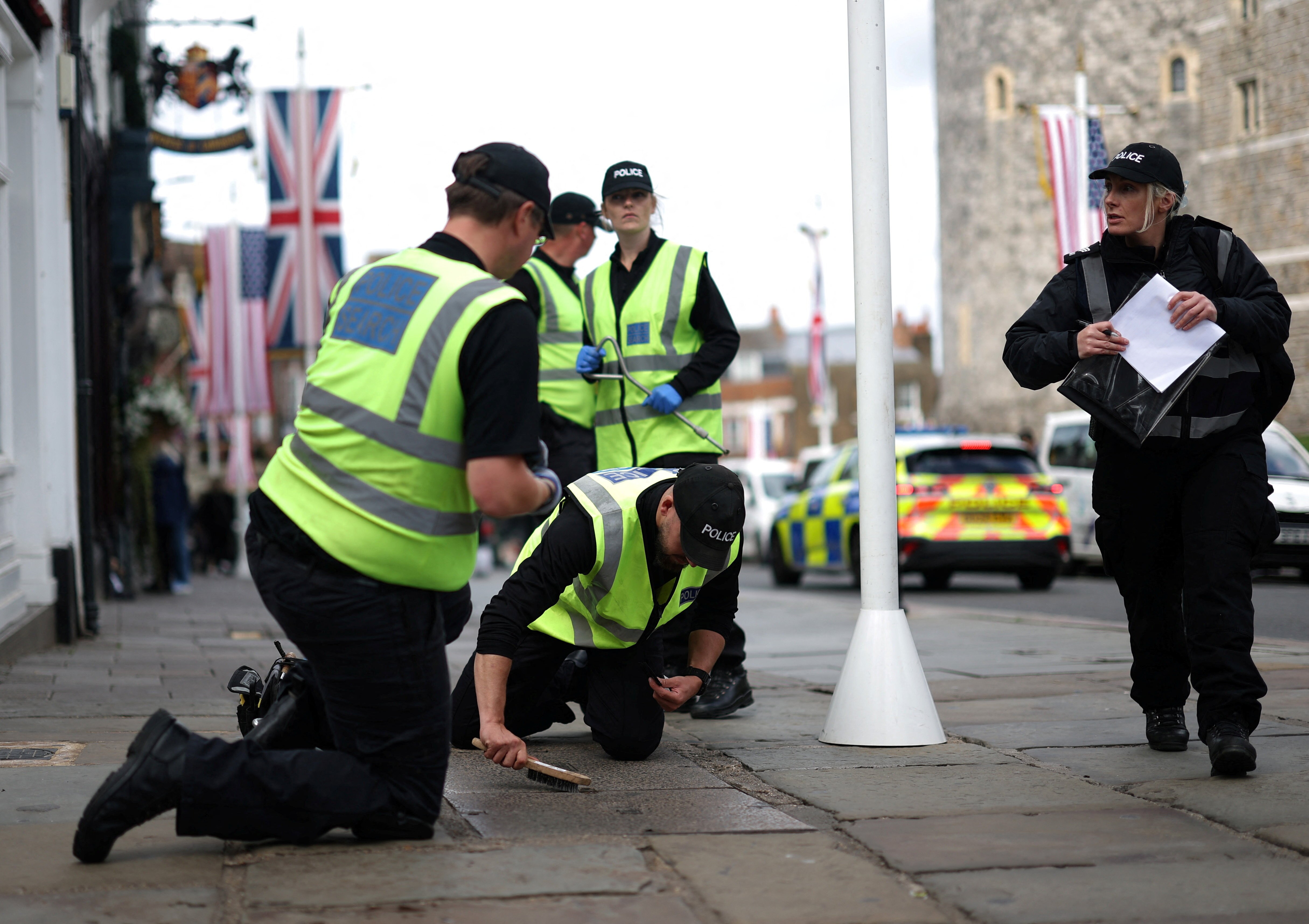 Police officers brushing the pavement out the front of Windsor Castle.