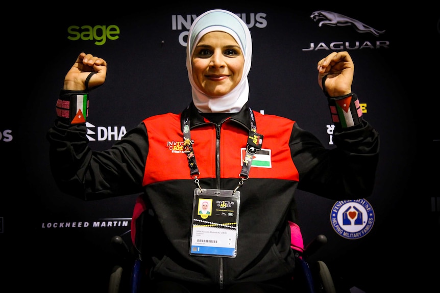 Ulfat Yaseen Ahmad Al-Zwiri smiling post race with her arms in the air.