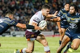 James Roberts looks for a gap in the Cowboys' defence.