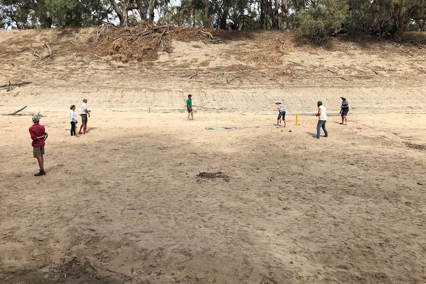 Players on the dry and sandy field