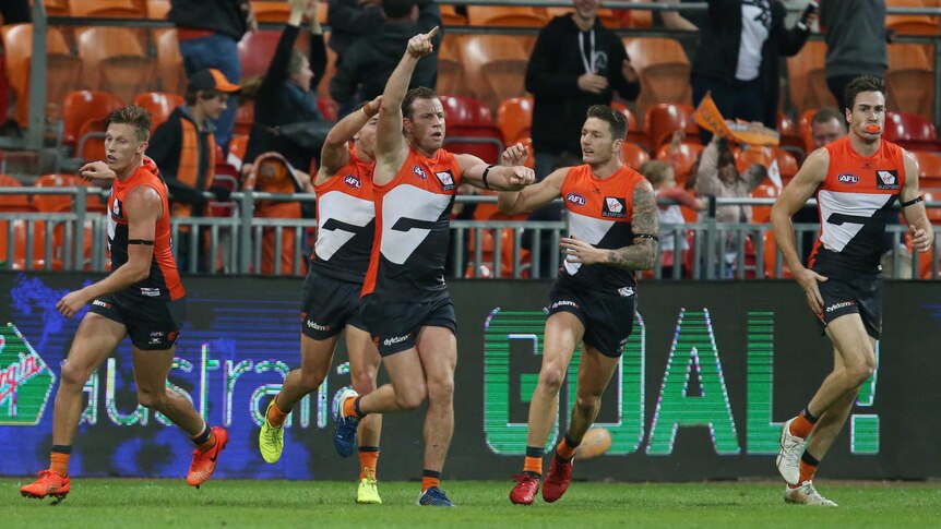 Steve Johnson (C) of GWS celebrates scoring the winning goal against Collingwood in Sydney on May 13, 2017.