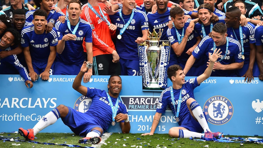 Chelsea's Didier Drogba, Cesar Azpilicueta and John Terry (C) with the Premier League trophy.