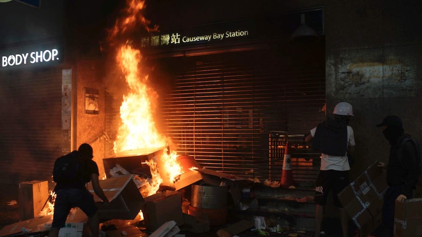 Protesters set cardboard boxes on fire at the entrance to the Causeway Bay station in Hong Kong.
