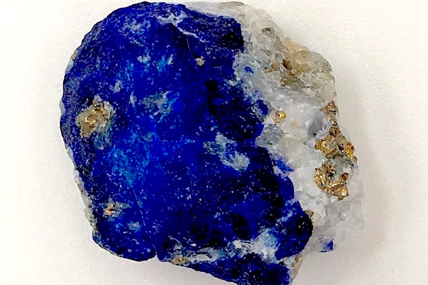 A piece of lapis lazuli, a blue stone flecked with bits of gold and white rock.