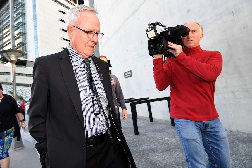 Graham Morant leaves the Supreme Court followed by reporters.