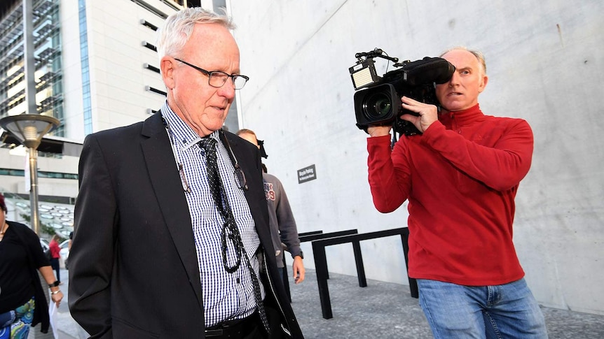 Graham Morant leaves the Supreme Court followed by reporters.