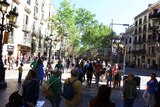 Tourists walk along a busy street in Barcelona