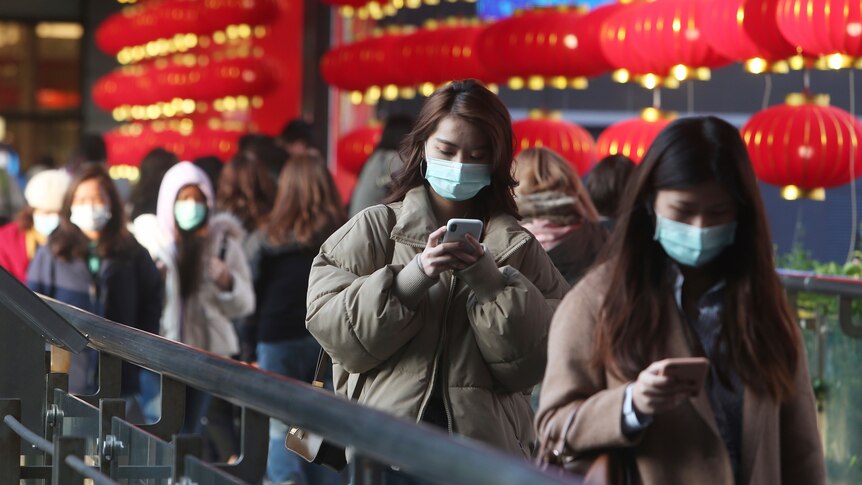 People wear face masks and walk at a shopping mall in Taipei, Taiwan.