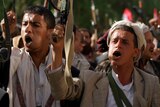 Tribal militia loyal to Shiite Houthi rebels in Yemen raise their weapons