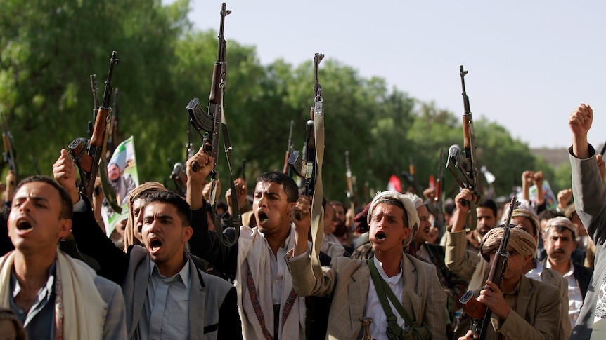 Tribal militia loyal to Shiite Houthi rebels in Yemen raise their weapons