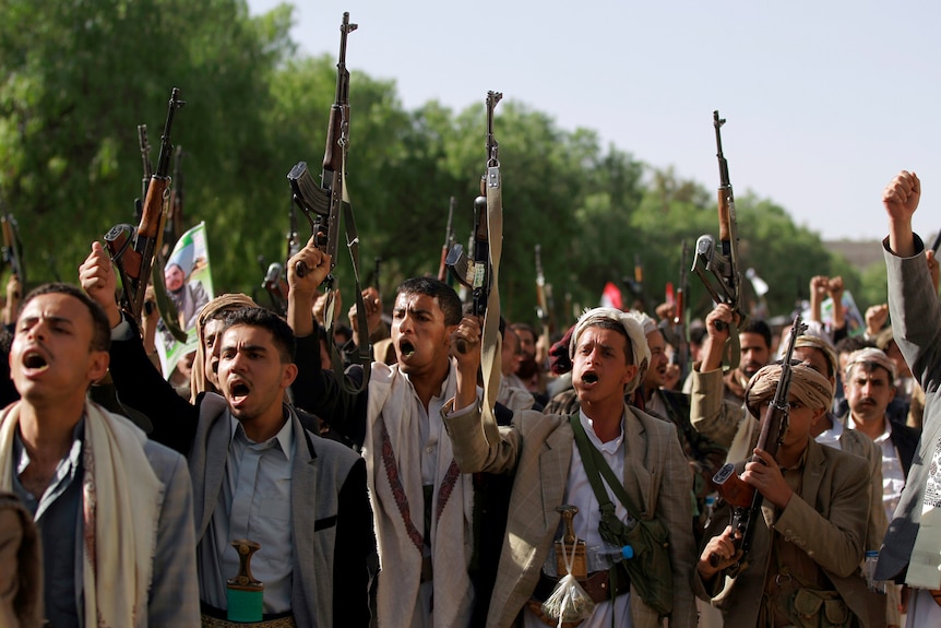 Tribal militia loyal to Shiite Houthi rebels in Yemen raise their weapons