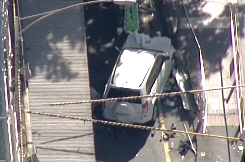Aerial shot of a white vehicle on a street