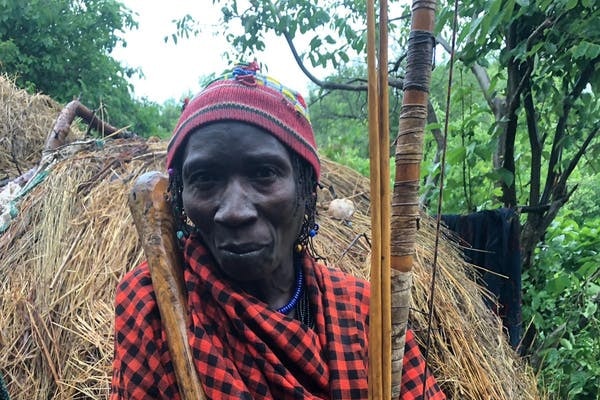 A Hadza tribesman holds out a handful of honey