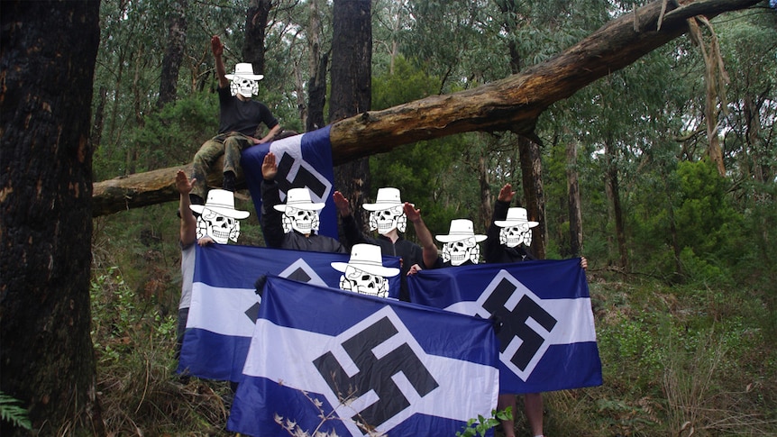 Seven members of the neo-Nazi group Antipodean Resistance holding flags with swastikas in a Victorian forest.