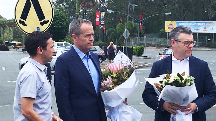Opposition Leader Bill Shorten holding flowers outside Dreamworld
