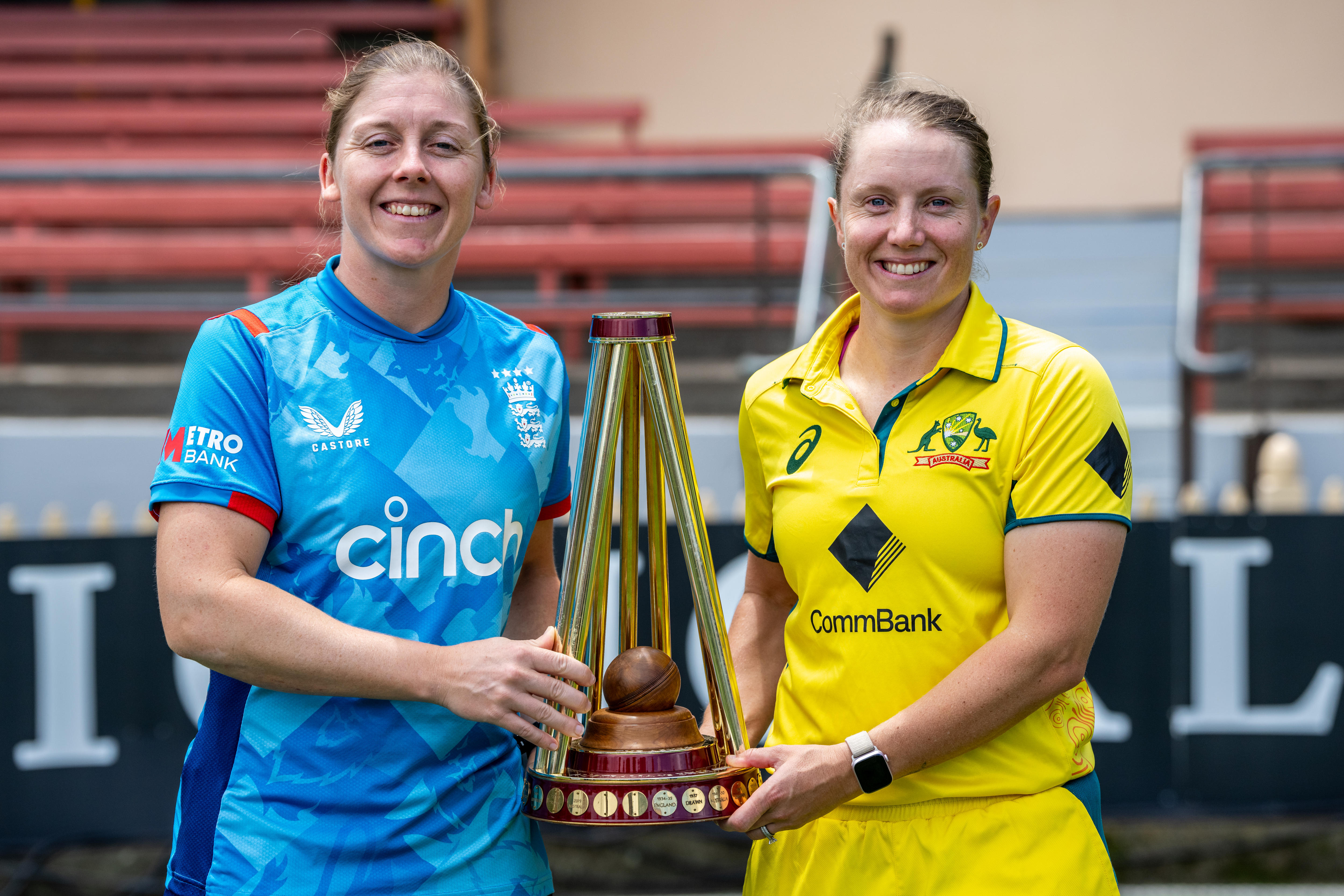 Heather Knight and Alyssa Healy pose for a photo in their respective ODI kits and holding the trophy