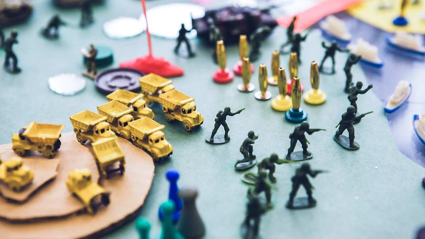 Close up view of the world peace game board and figurines.