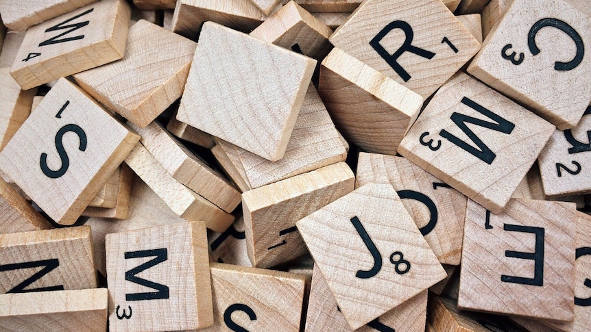 Close up of scattered wooden scrabble tiles