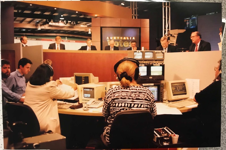 Kerry O'Brien and Antony Green and panellists on set and production team looking at monitors.