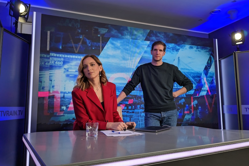 Two people at the news desk.