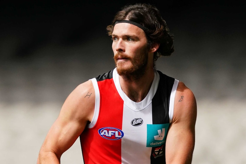 Dylan Roberton holds the ball in two hands as he plays against North Melbourne during the 2020 AFL season.
