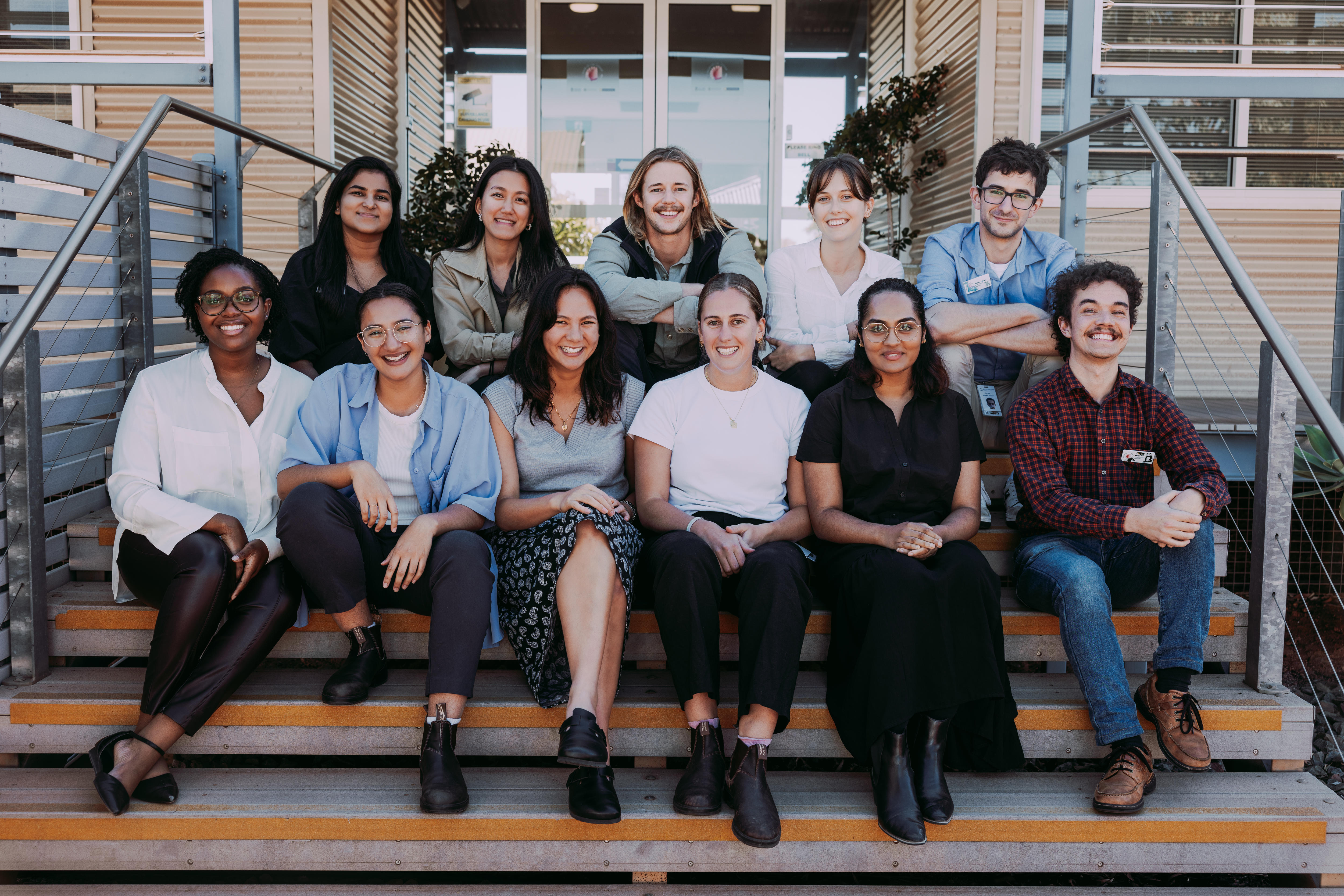 A group of medical students seated on a step.  