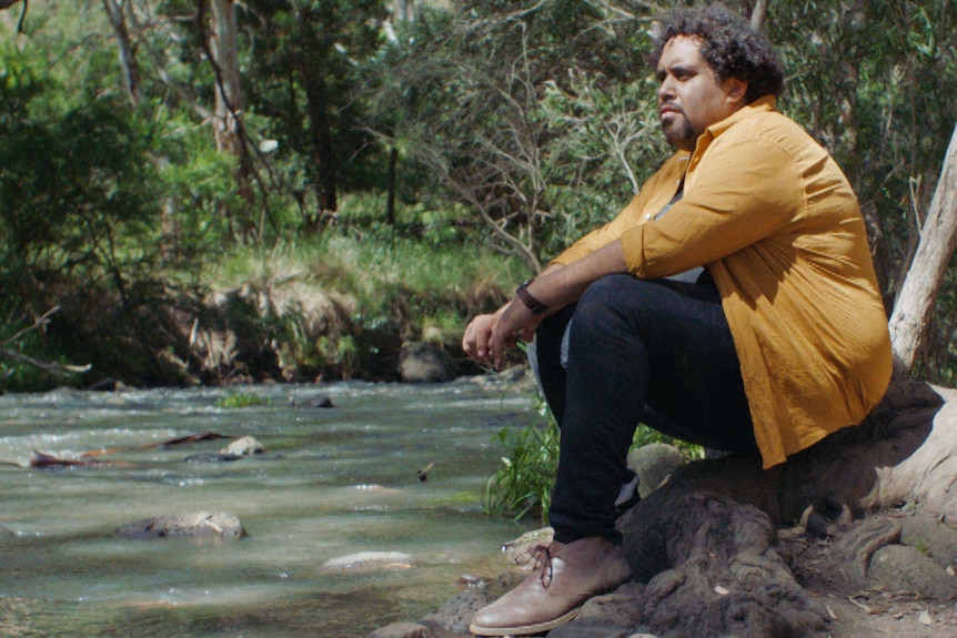 Indi Clarke sitting by the river