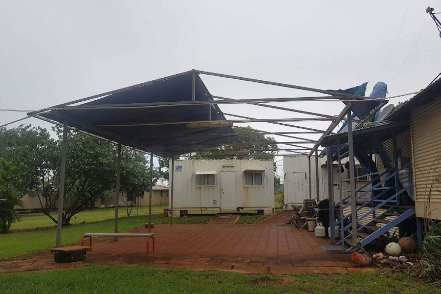 A shelter missing half of its roof.