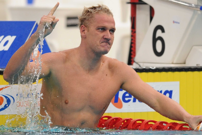 Brenton Rickard holds his finger up in celebration at the end of his lane