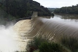 Water spills over Travallyn Dam near Launceston