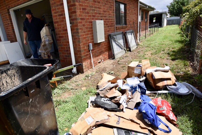 Matthew Willey of Euroa cleans out some of the flood-damaged possessions from his house.