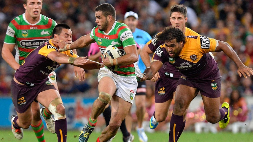 Bursting through ... Greg Inglis proves too much to handle for the Broncos' defence.