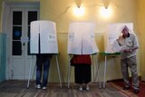 People stand in voting booths in Georgia