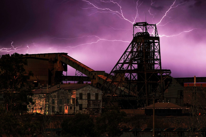 Lightning shoots out across the night-time Broken Hill sky, just past the city's North Mine