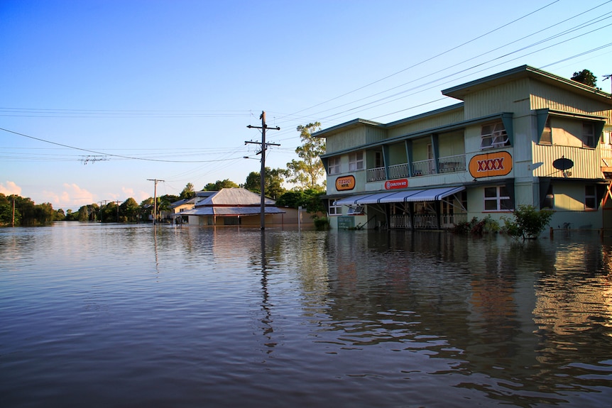 A suburban street and pub flooded with water.