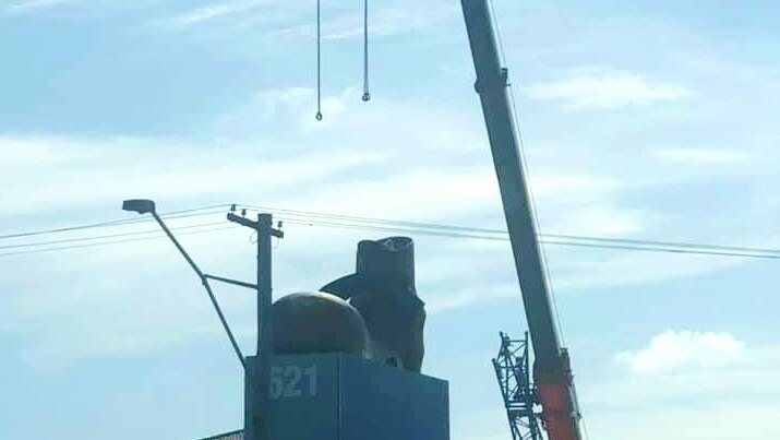A crane is spotted ready to remove the boot from the roof of 62 Gympie road chermside.