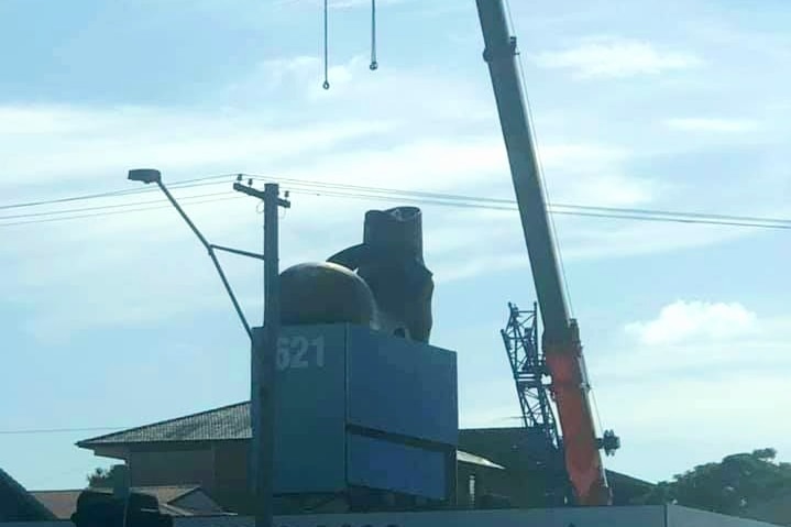 A crane is spotted ready to remove the boot from the roof of 62 Gympie road chermside.
