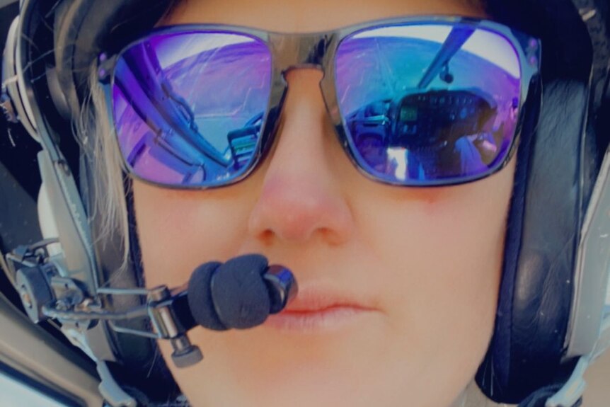 Karina Hampton wearing sunglasses and headset.